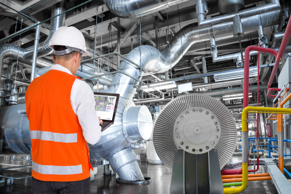 Man in high vis monitoring HVAC system